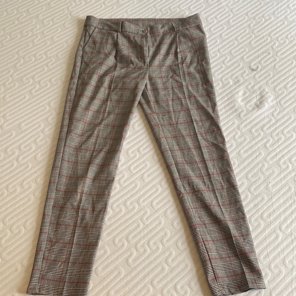 Grey slim trousers with red black and white checkered pattern.